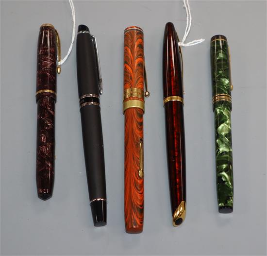 A group of five vintage fountain pens, including a Watermans orange and black marble effect pen